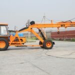 ACE 14XW mobile crane parked outdoors in an industrial area in India.