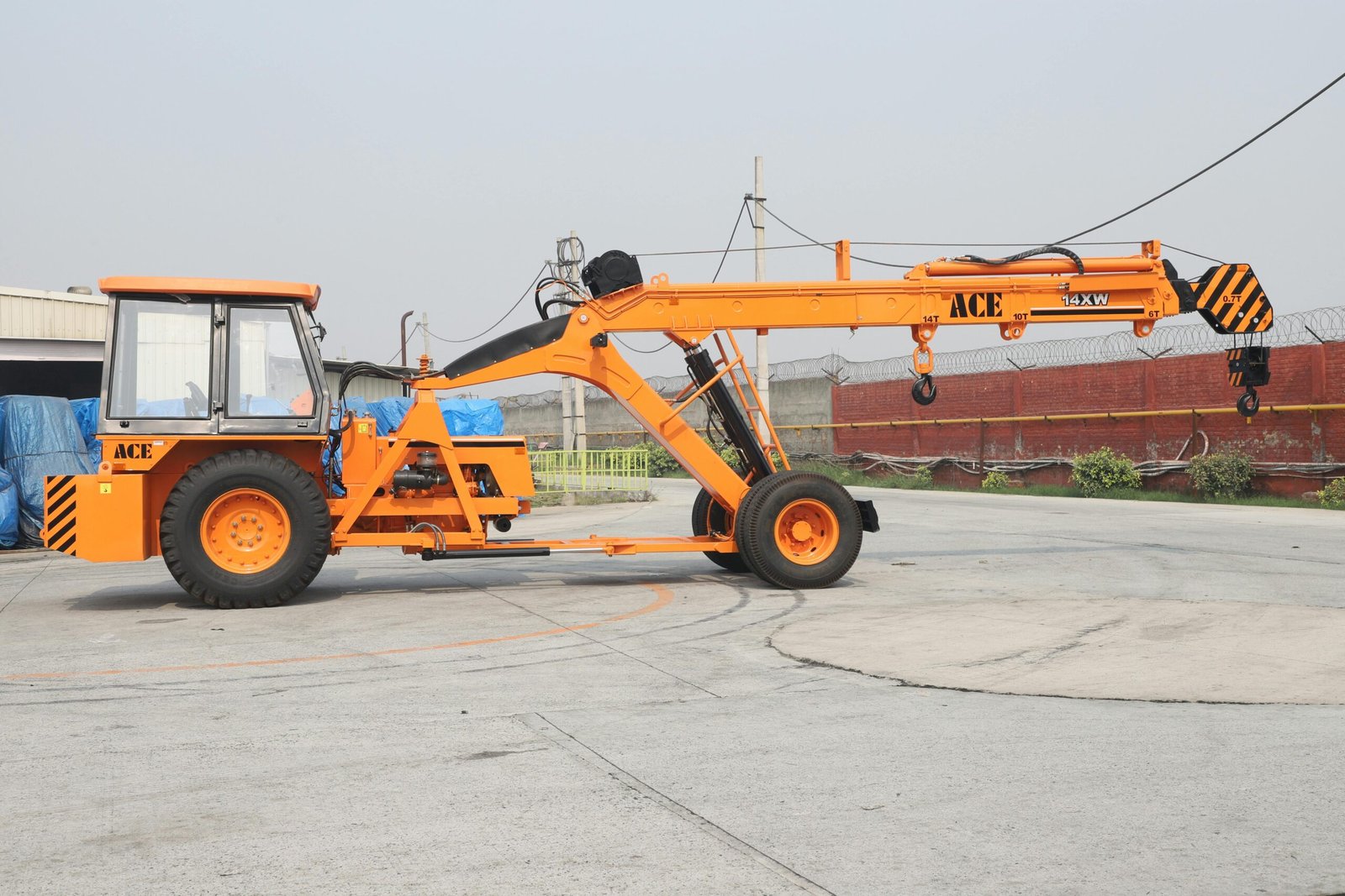 ACE 14XW mobile crane parked outdoors in an industrial area in India.